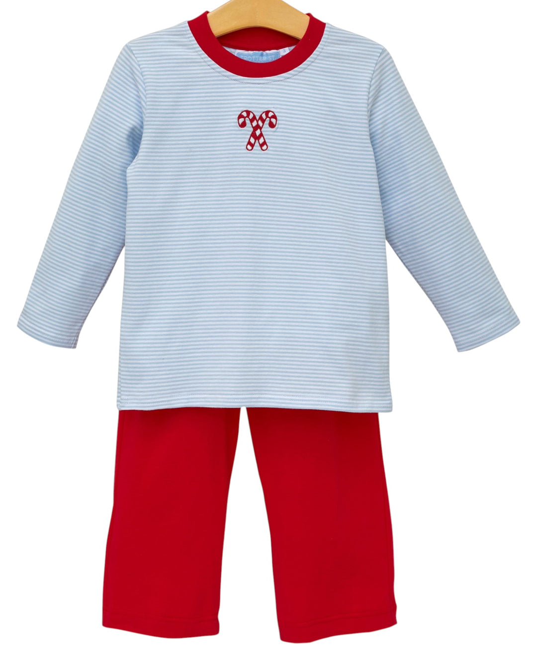 Children's outfit with blue and red striped shirt and red pants on a hanger.