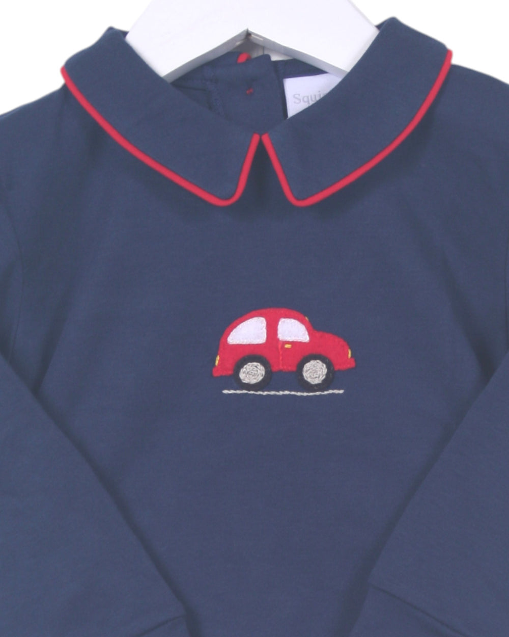 Navy blue shirt with red car applique on a white background