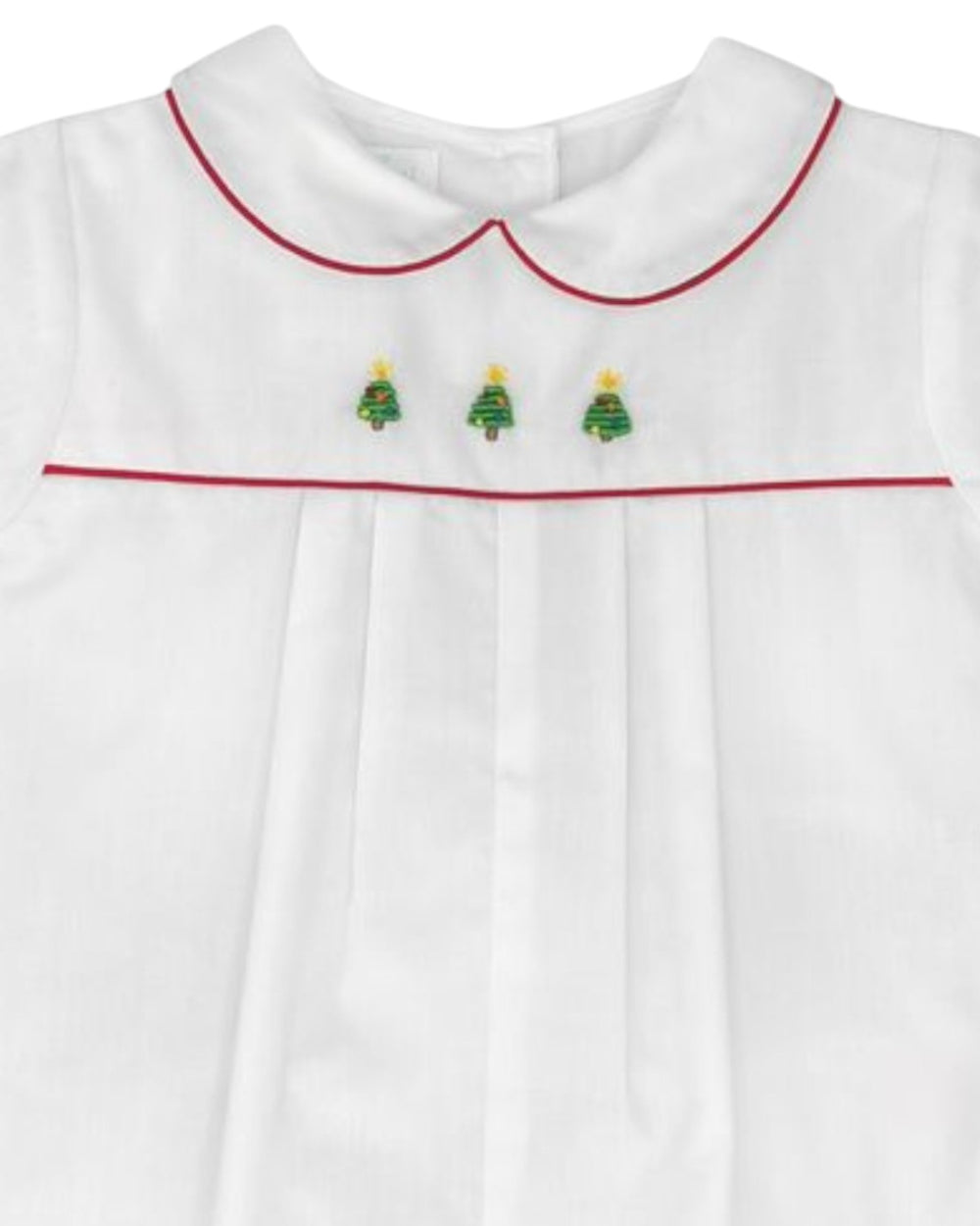 White shirt with red trim and embroidered green trees on a white background