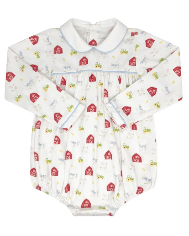 A baby long-sleeve romper in white fabric with a repeating pattern of red barns, green tractors, and small farm animals, featuring a Peter Pan collar and light blue piping details, that store