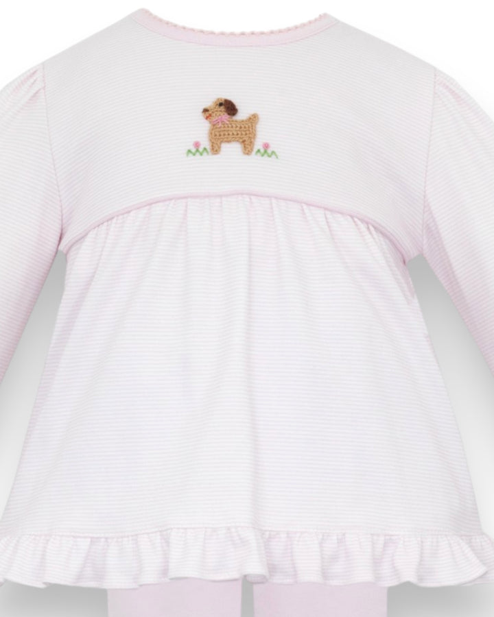 A close-up of a light pink and white vertically striped long-sleeve baby top, showing the back view with a small embroidered dog motif on the upper back, that store