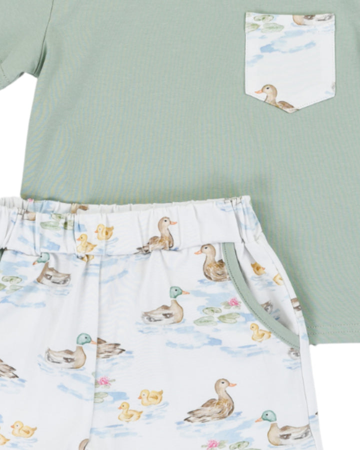 Green shirt with duck patterned shorts on a white background