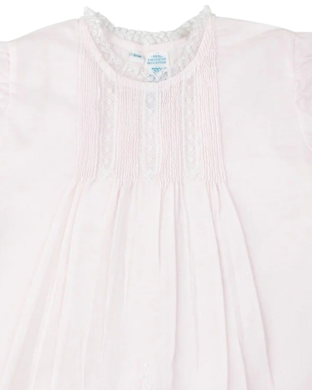 Close-up of a light pink garment with a subtle pattern on a white background