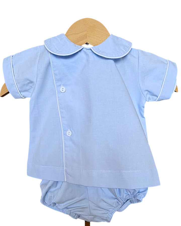 Light blue baby outfit with shirt and bloomers on a hanger against a white background