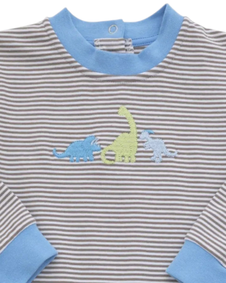 A close-up of a baby long-sleeve shirt with gray and white horizontal stripes, light blue ribbed collar and cuffs, and embroidered dinosaur motifs in light blue, yellow-green, and light blue on the chest, that store