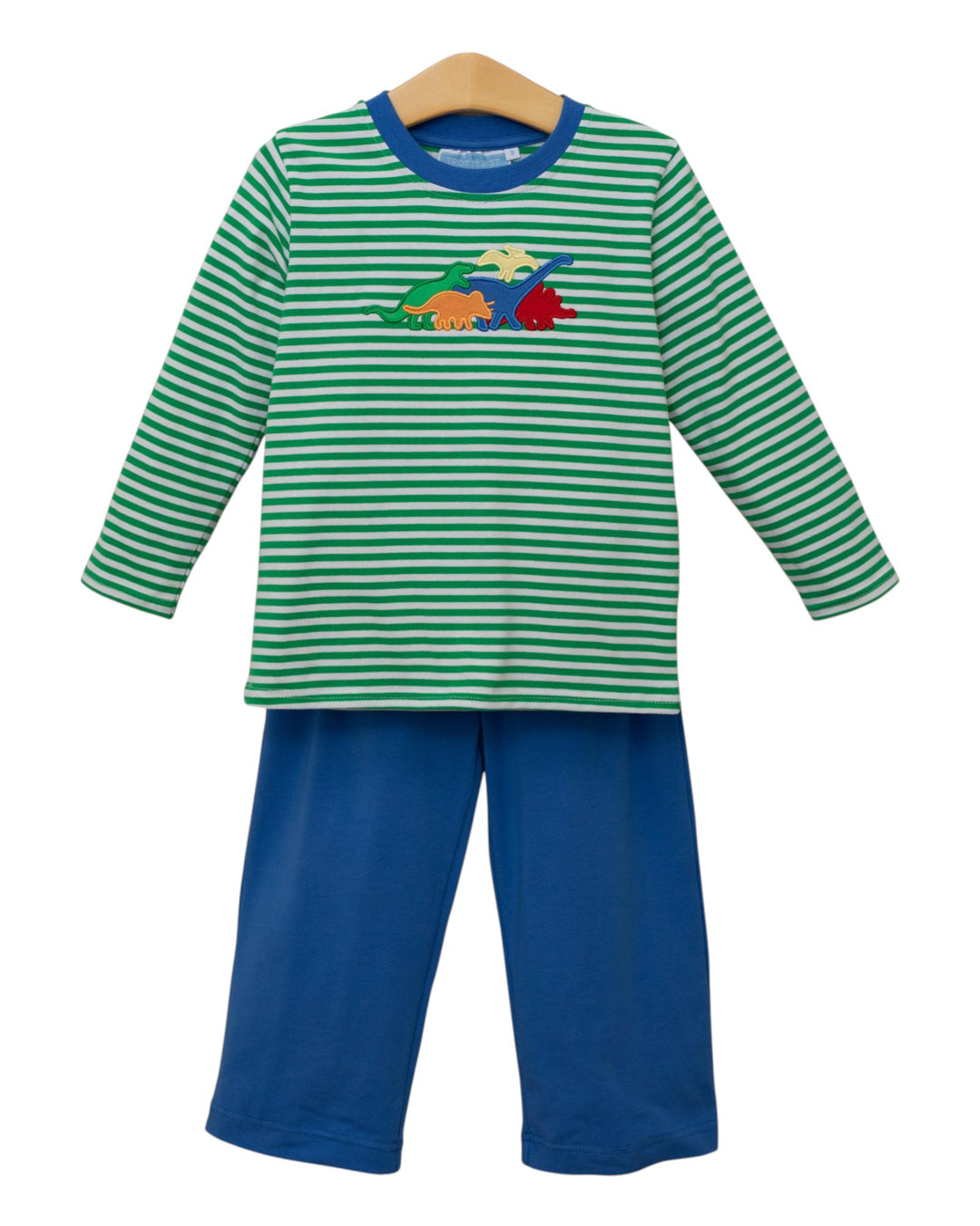 Children's outfit with green and white striped shirt and blue pants on a hanger