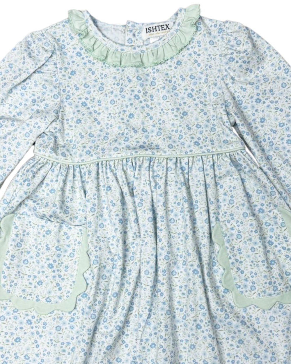 Children's dress with floral pattern and green accents on a white background