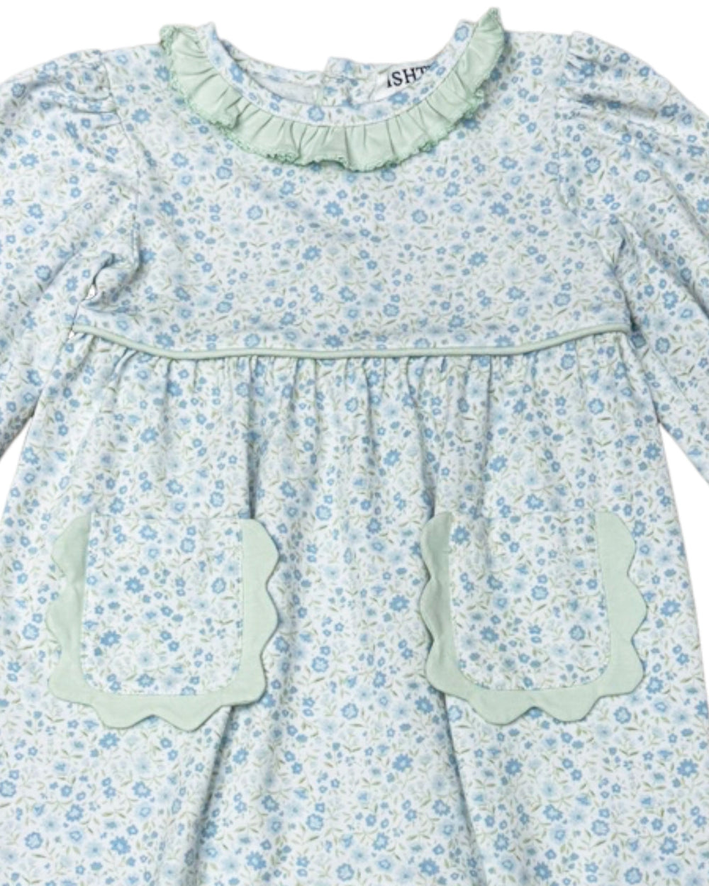 Floral dress with ruffled collar and pocket details on a white background