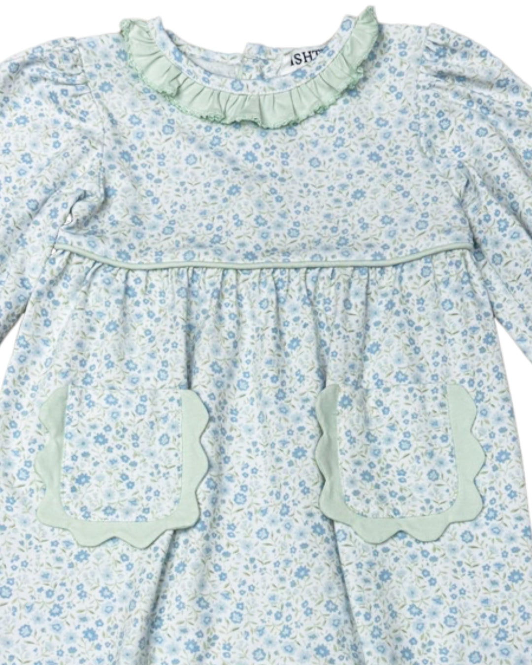 Floral dress with ruffled collar and pocket details on a white background