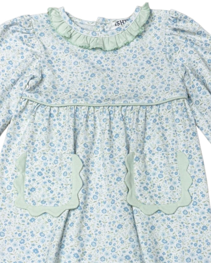 Floral dress with ruffled collar and pocket details on a white background