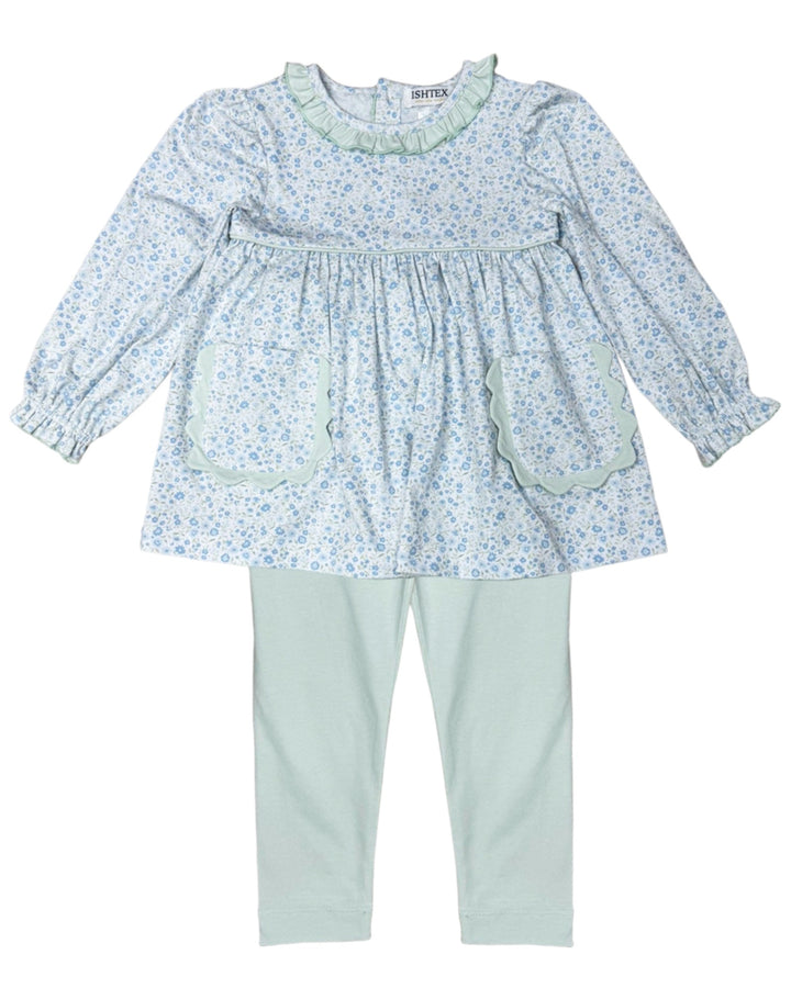 Children's outfit with floral top and light blue pants on a white background