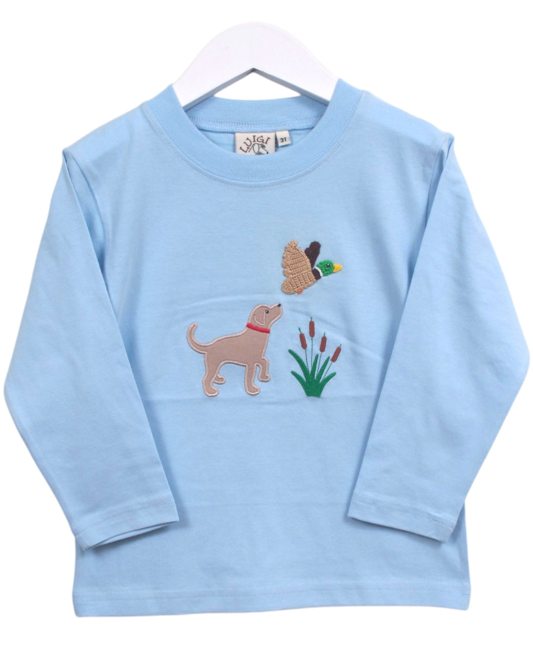 A light blue long-sleeve baby t-shirt on a white hanger, featuring embroidered graphics of a tan dog, a duck, and green reeds on the front, that store