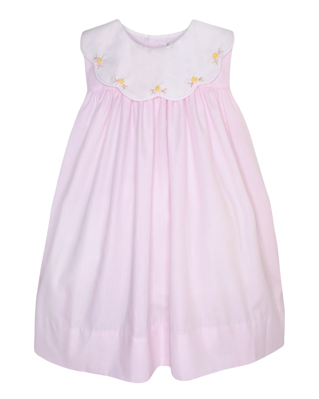 Pink dress with white collar and yellow flower details on a white background
