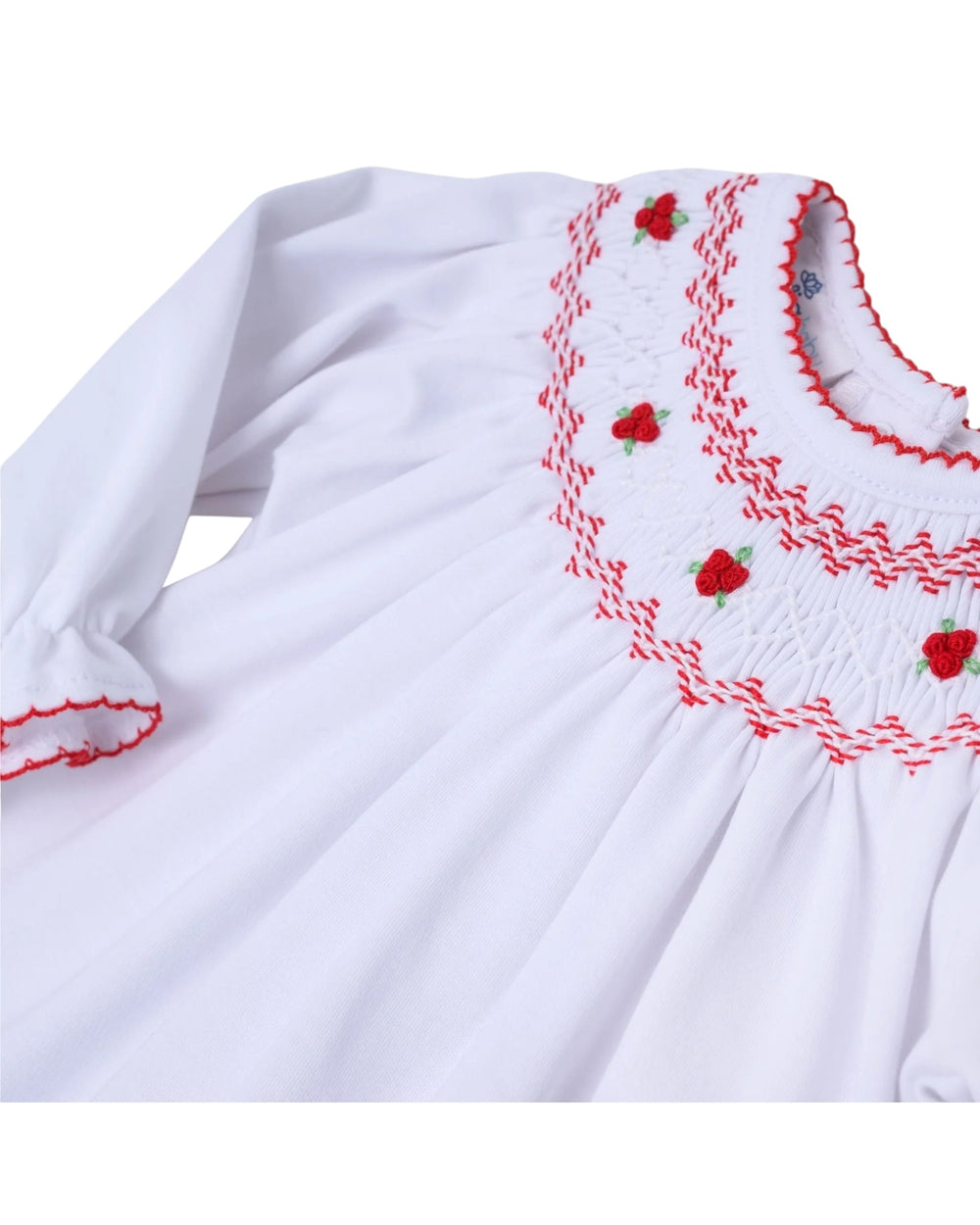 White dress with red embroidery on a white background