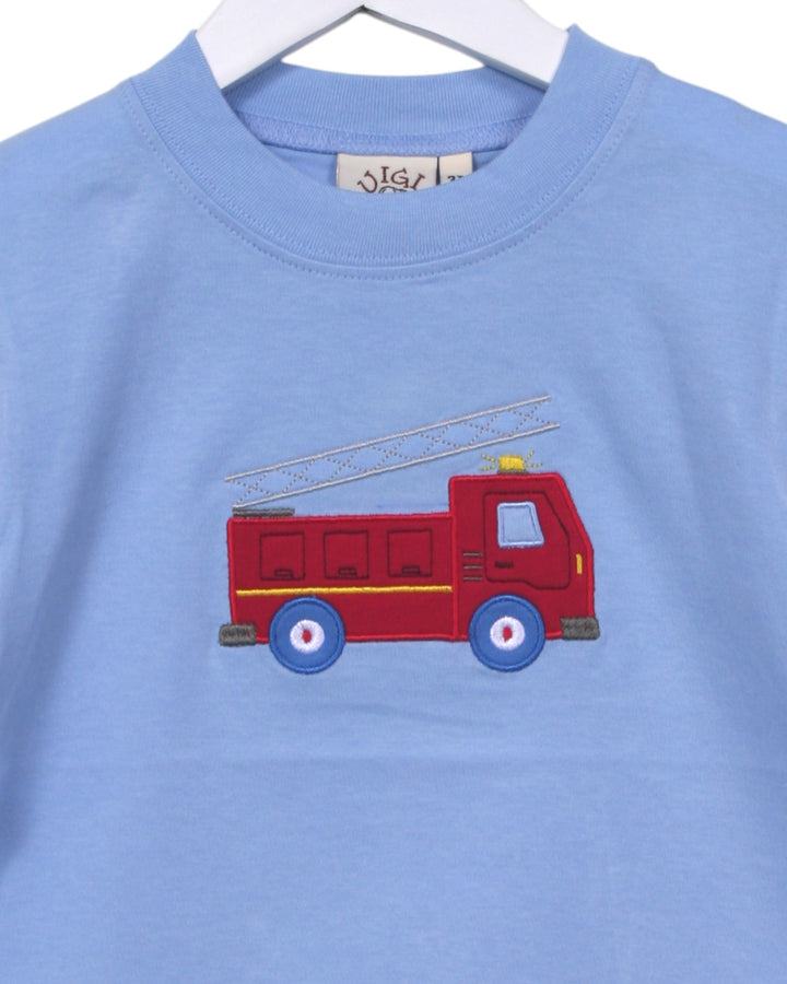 Blue shirt with a red fire truck design on a hanger