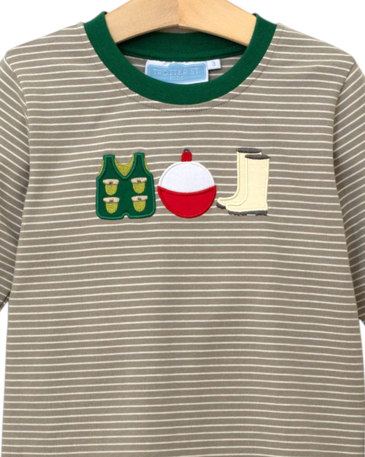 Striped shirt with fishing-themed appliqués on a hanger