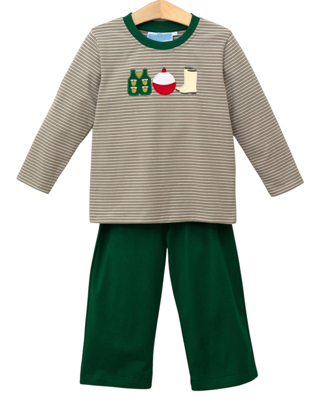 Children's outfit with striped shirt and green pants on a hanger