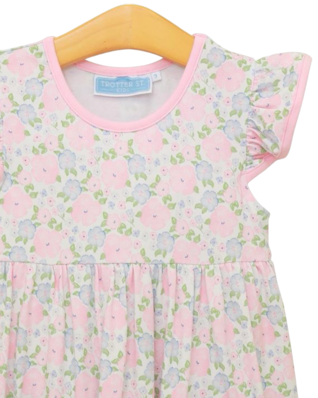 Floral dress on a hanger with a visible brand label.