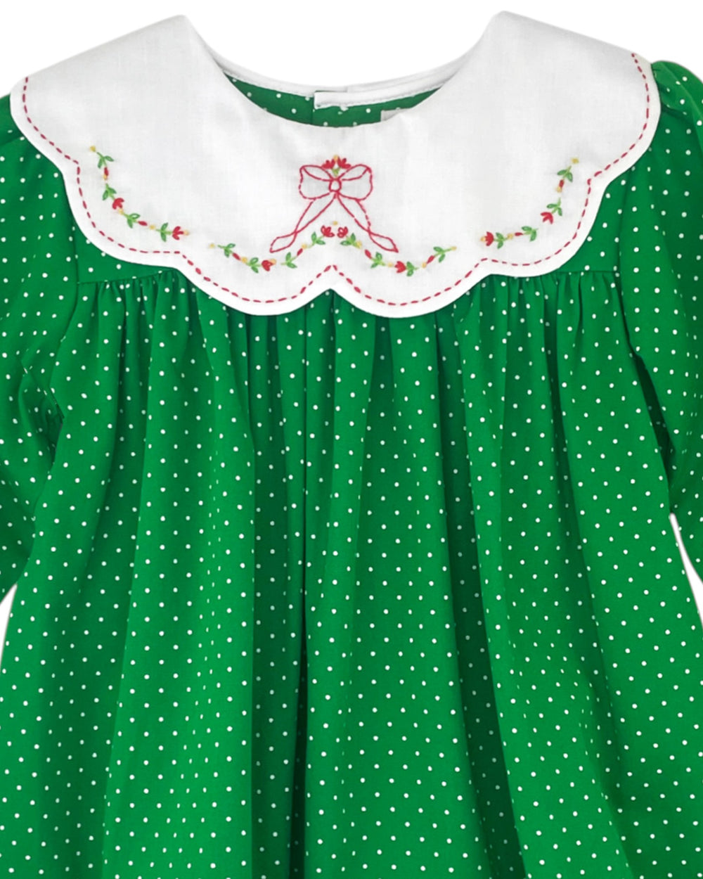 Green dress with white polka dots and embroidered collar featuring a bow design.