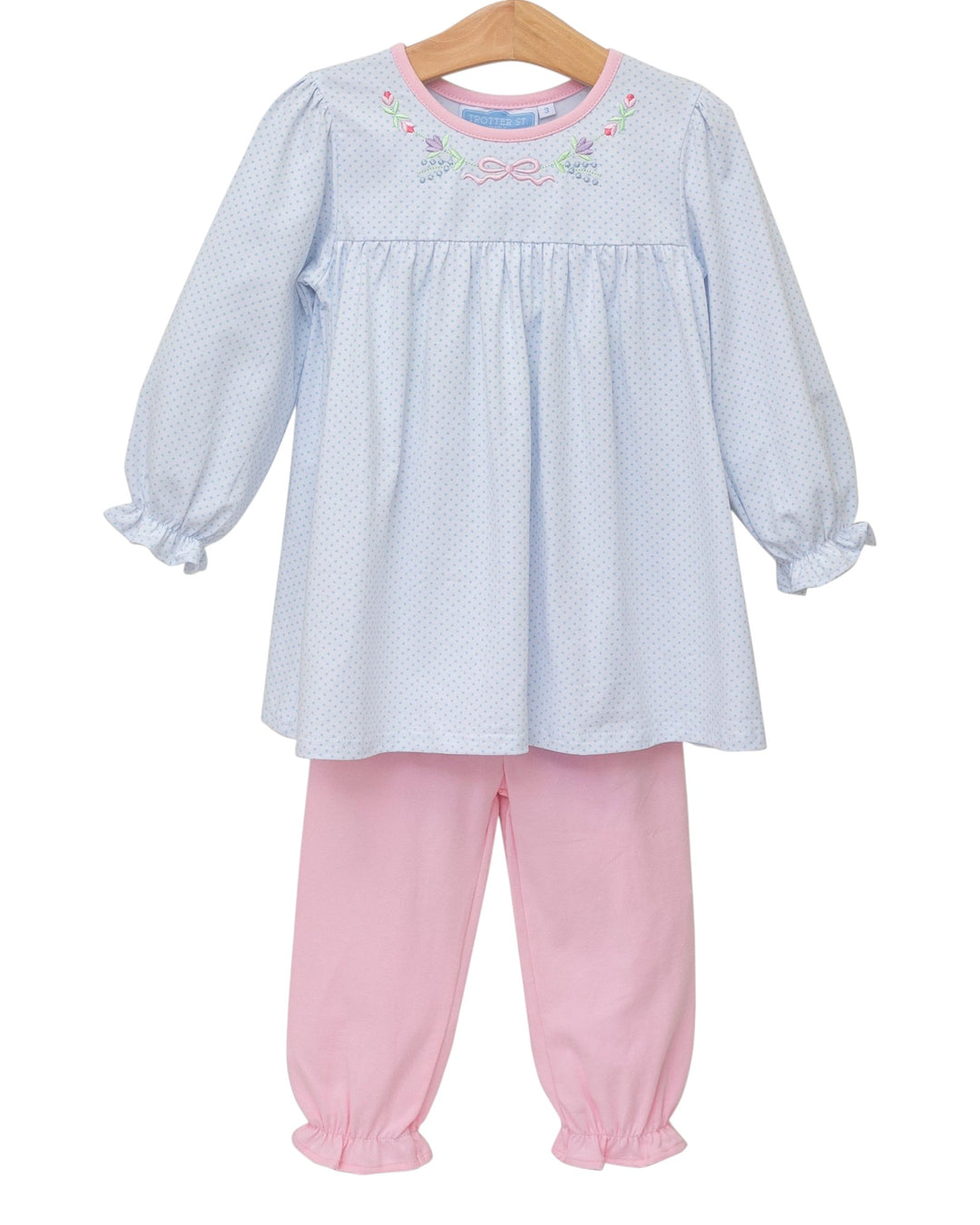 Children's outfit with a light blue top and pink pants on a white background
