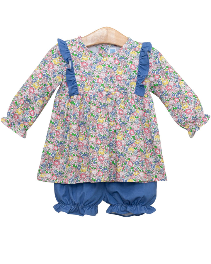 Floral dress with ruffled sleeves and blue bloomers on a white background