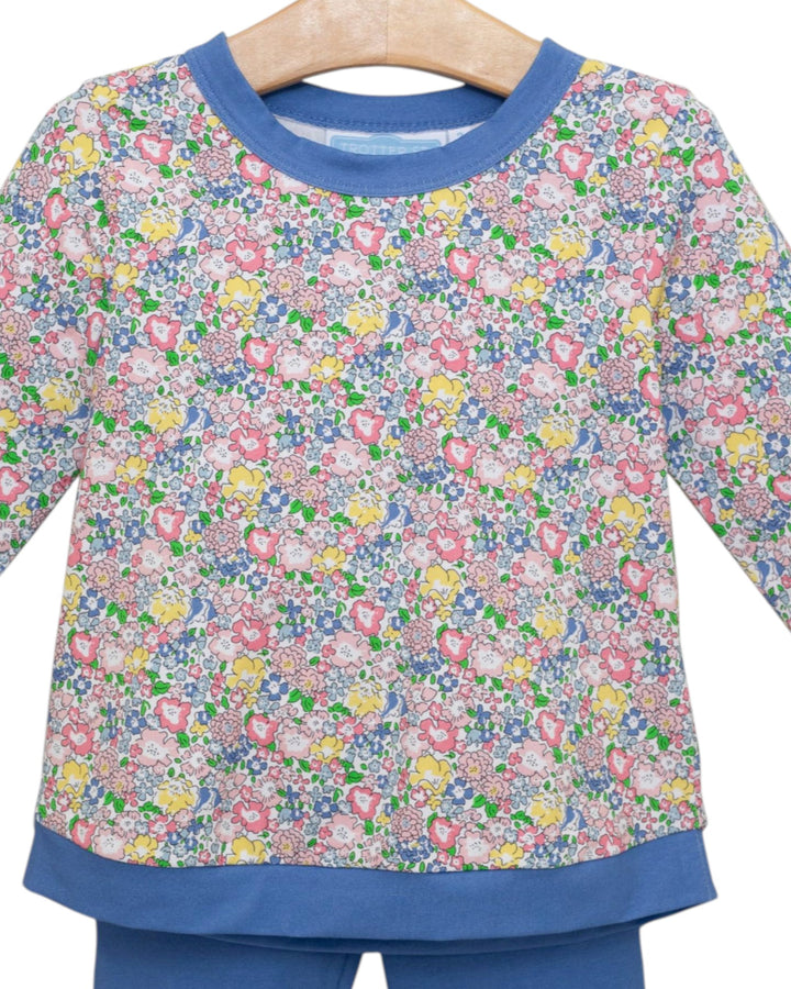 Children's floral long-sleeve shirt and pants on a hanger with a white background