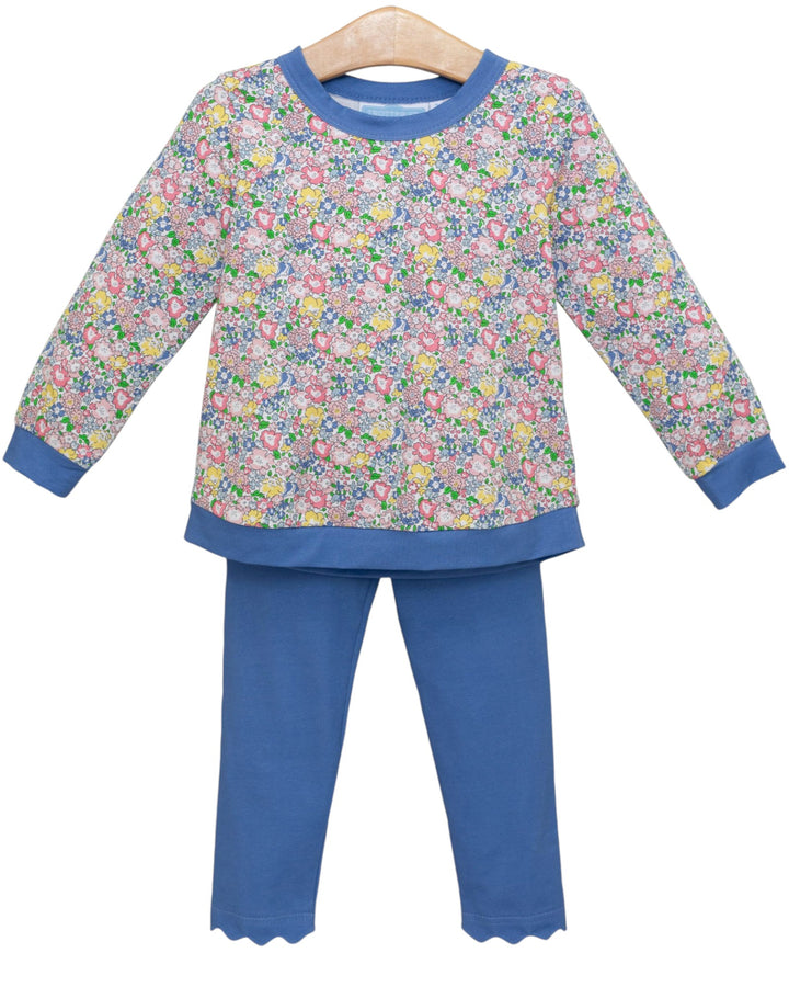 Children's pant set with floral top and blue pants on a hanger against a white background