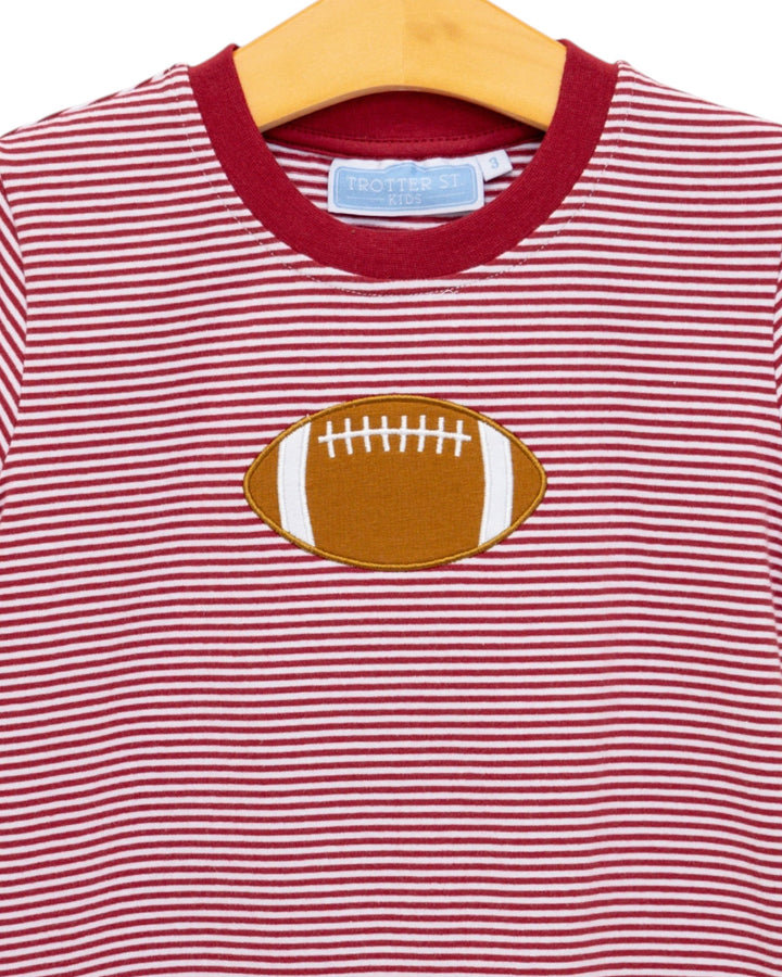 Red and white striped shirt with a football design on a hanger