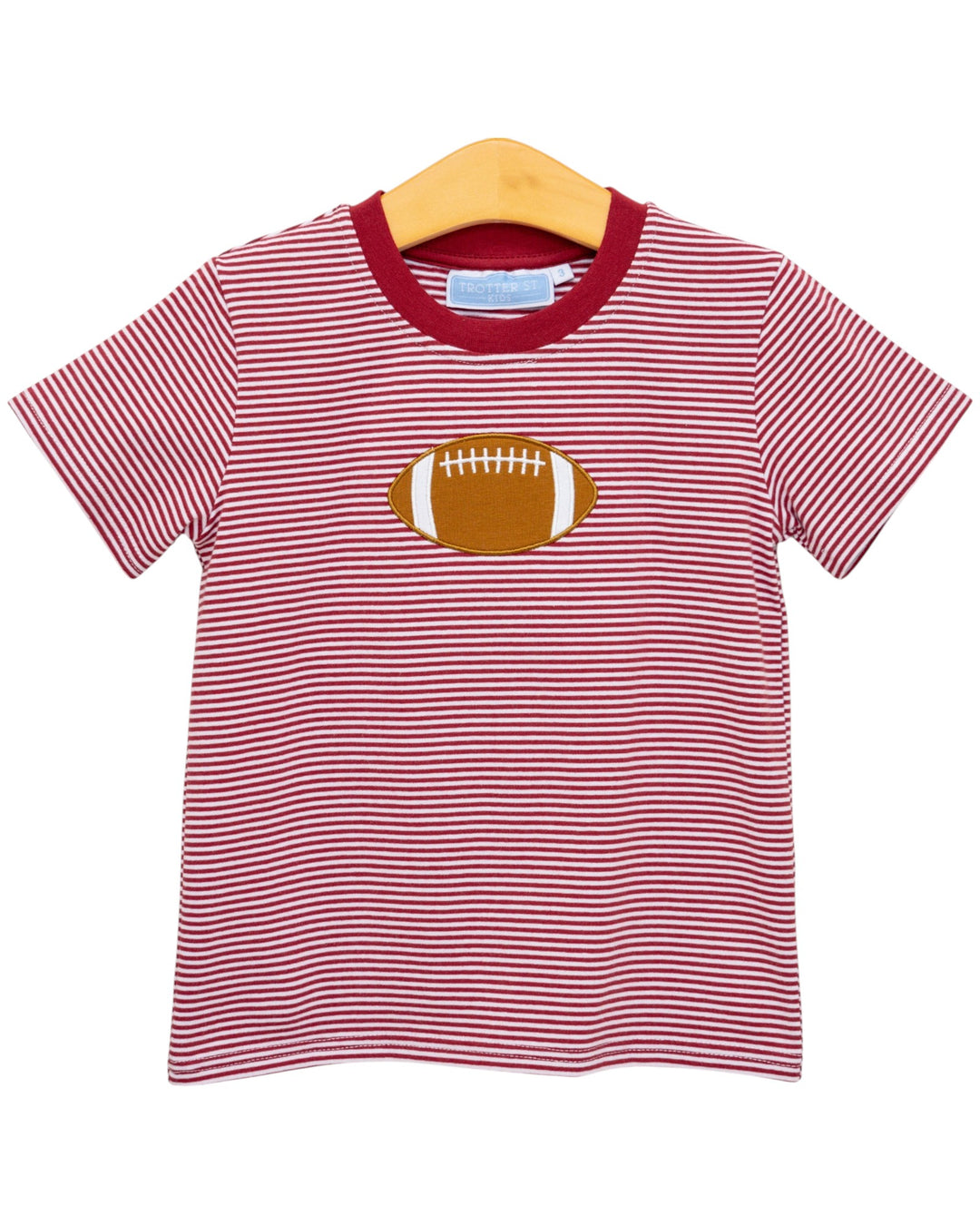 Red and white striped t-shirt with a football graphic on a hanger against a white background