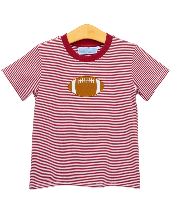 Red and white striped t-shirt with a football graphic on a hanger against a white background