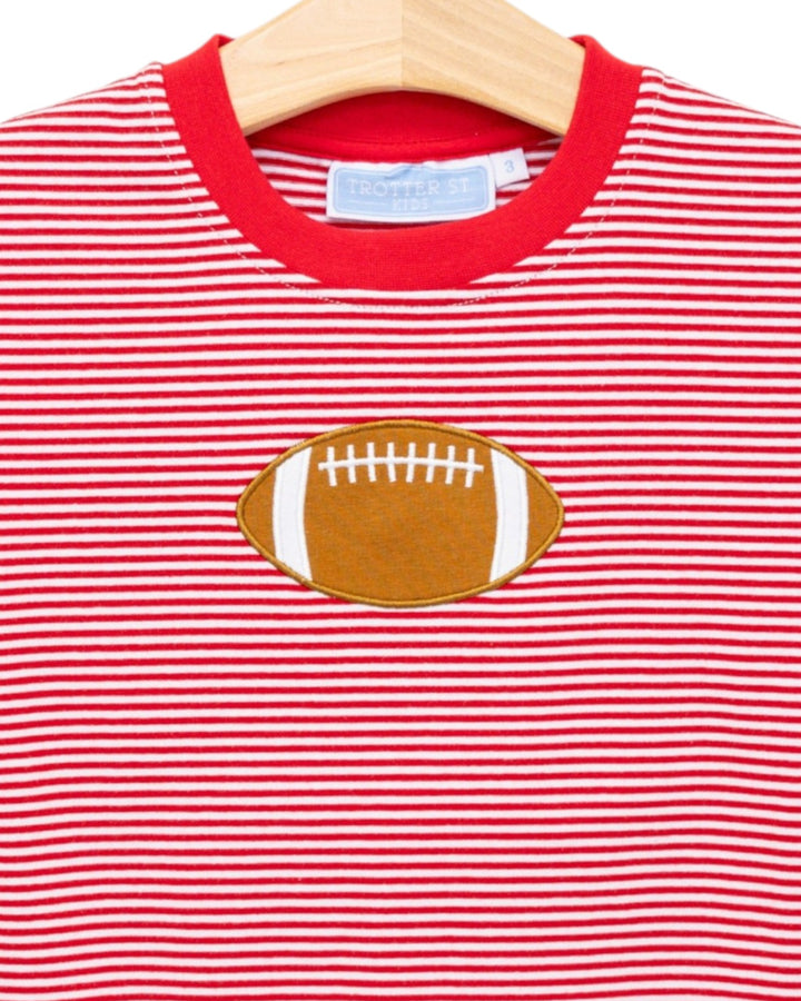Red and white striped shirt with a football patch on a hanger
