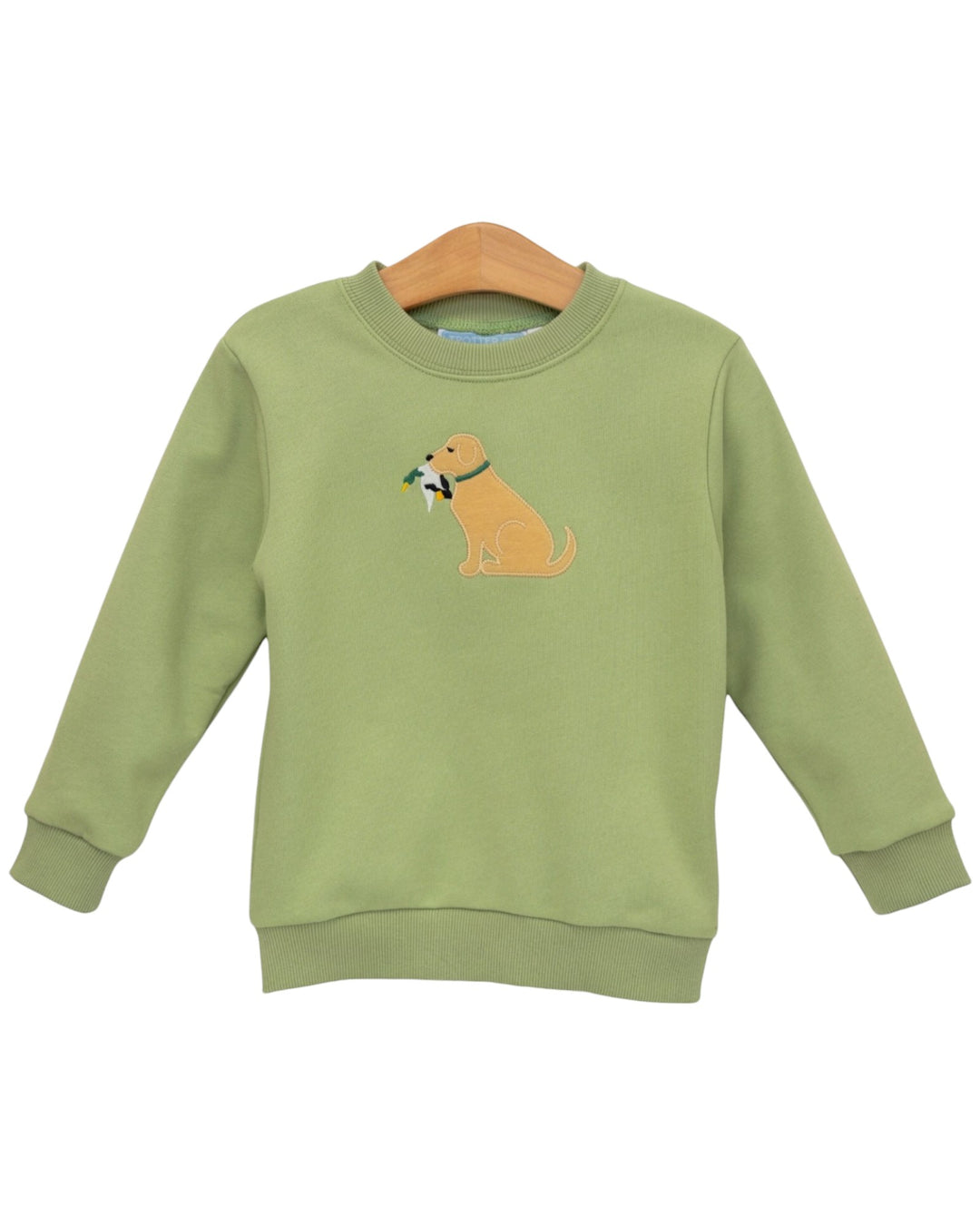 A sage green long-sleeve crewneck sweatshirt featuring an embroidered golden retriever dog holding a green leaf on the chest, displayed on a wooden hanger against a white background, that store