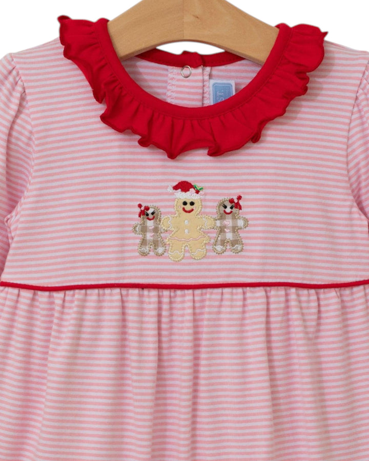 Pink and red striped dress with gingerbread design on a hanger