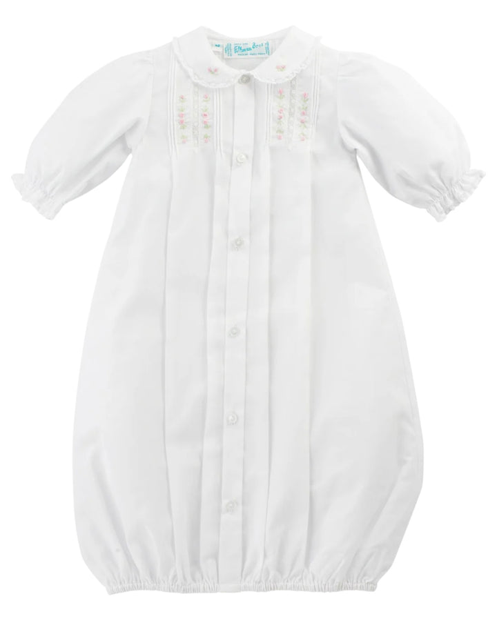 White baby gown with long sleeves on a white background