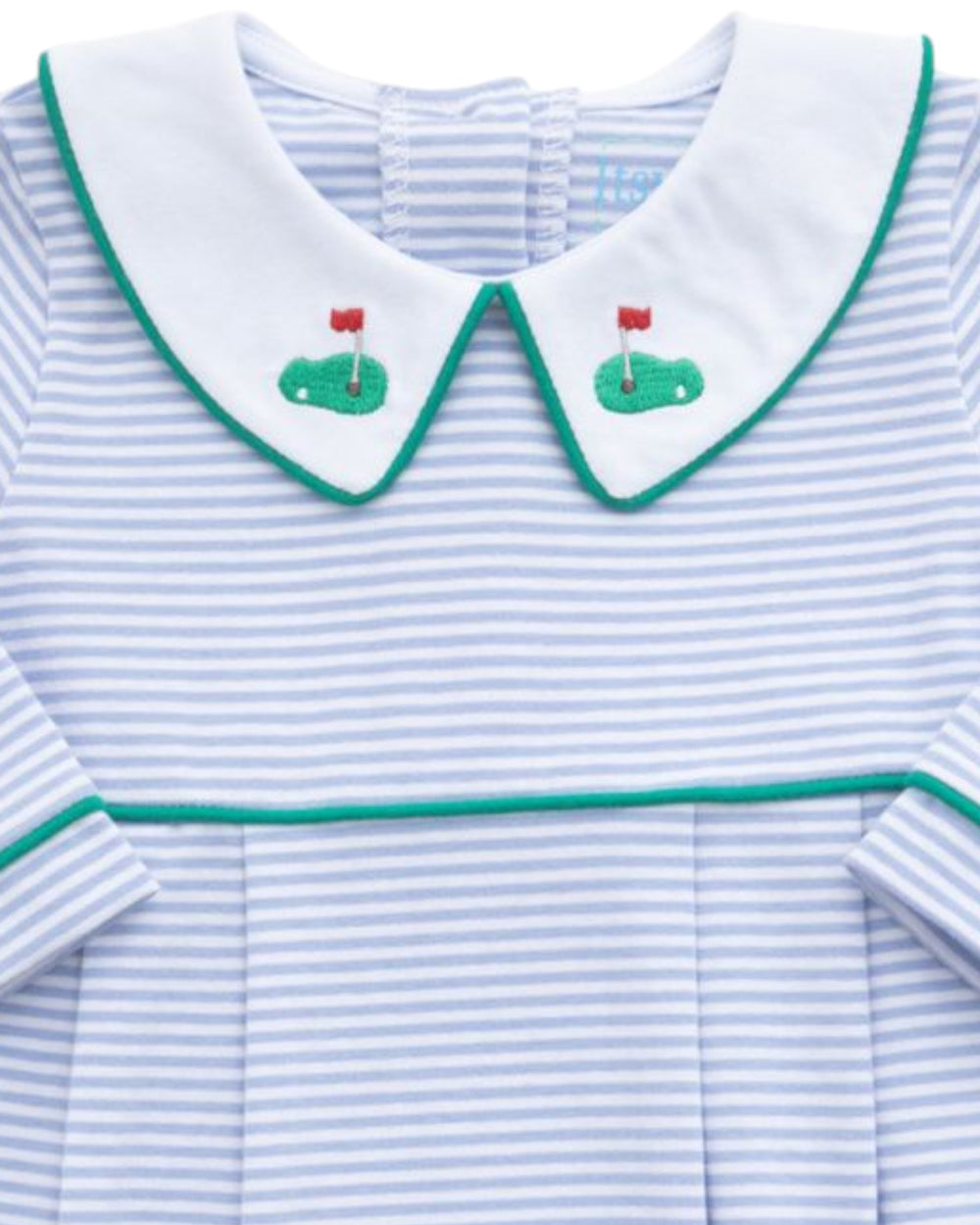 A close-up of a baby girl's long-sleeve dress featuring a white Peter Pan collar with green trim and embroidered green golf carts with red flags on the front. The body of the dress has light blue and white horizontal stripes, that store