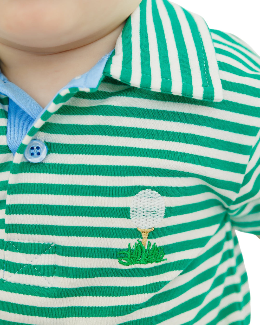 Green and white striped polo shirt with golf ball design on a child