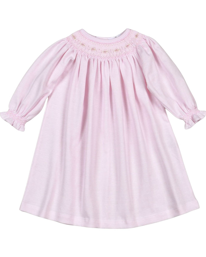 Pink dress with smocked bodice on a white background