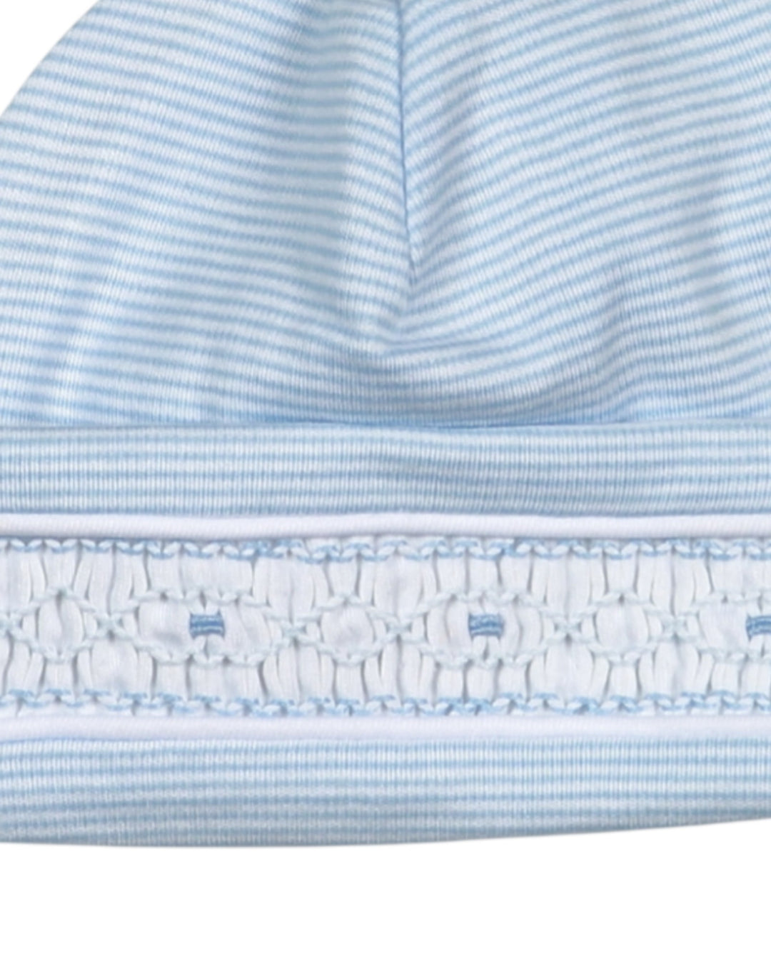 Close-up of a blue and white striped fabric with ruffled edge