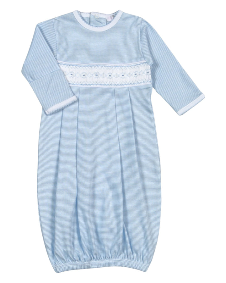 Light blue baby smocked gown with white lace trim on a white background
