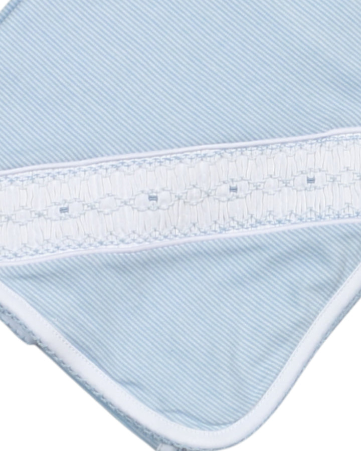 Close-up of a blue and white striped fabric with a textured border.