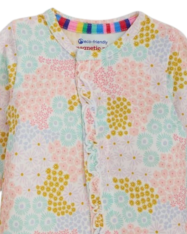 Floral patterned baby onesie with colorful magnetic design on a white background