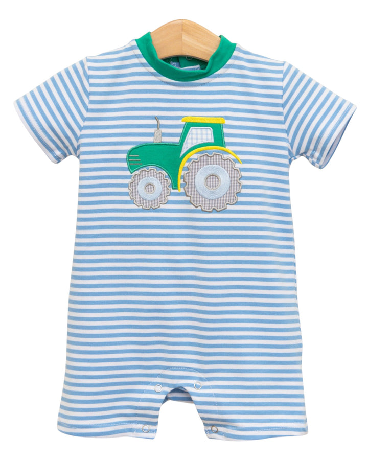 Striped baby romper with a tractor design on a white background