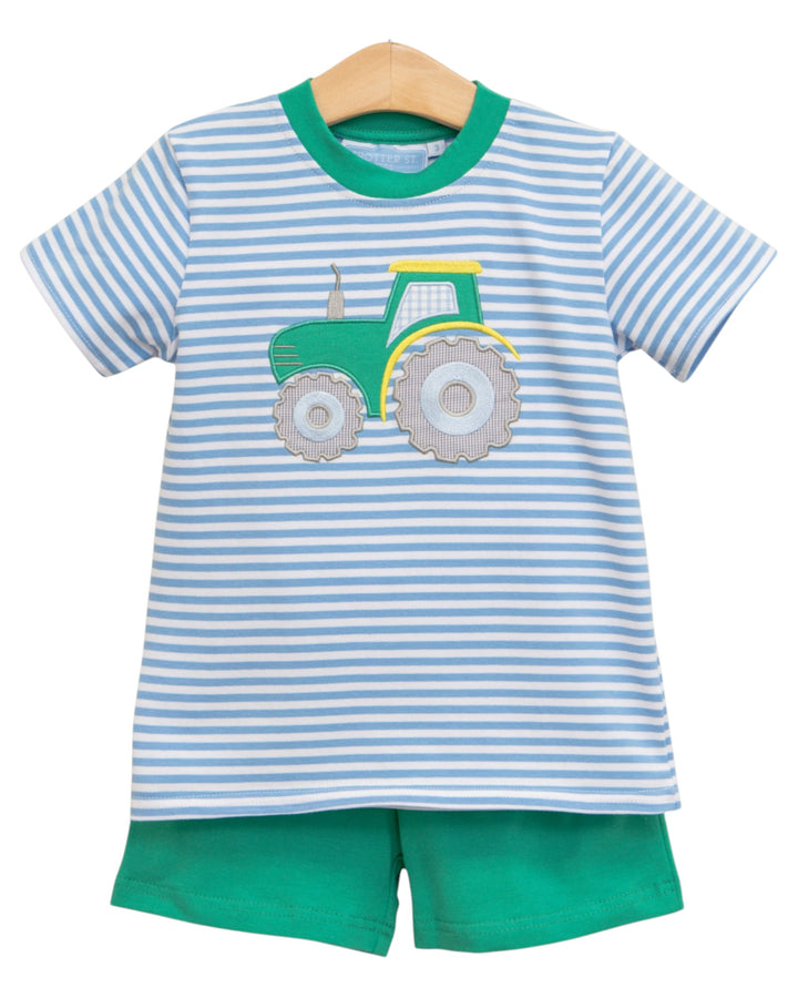 Children's outfit with striped shirt and green shorts featuring a tractor design on a white background.