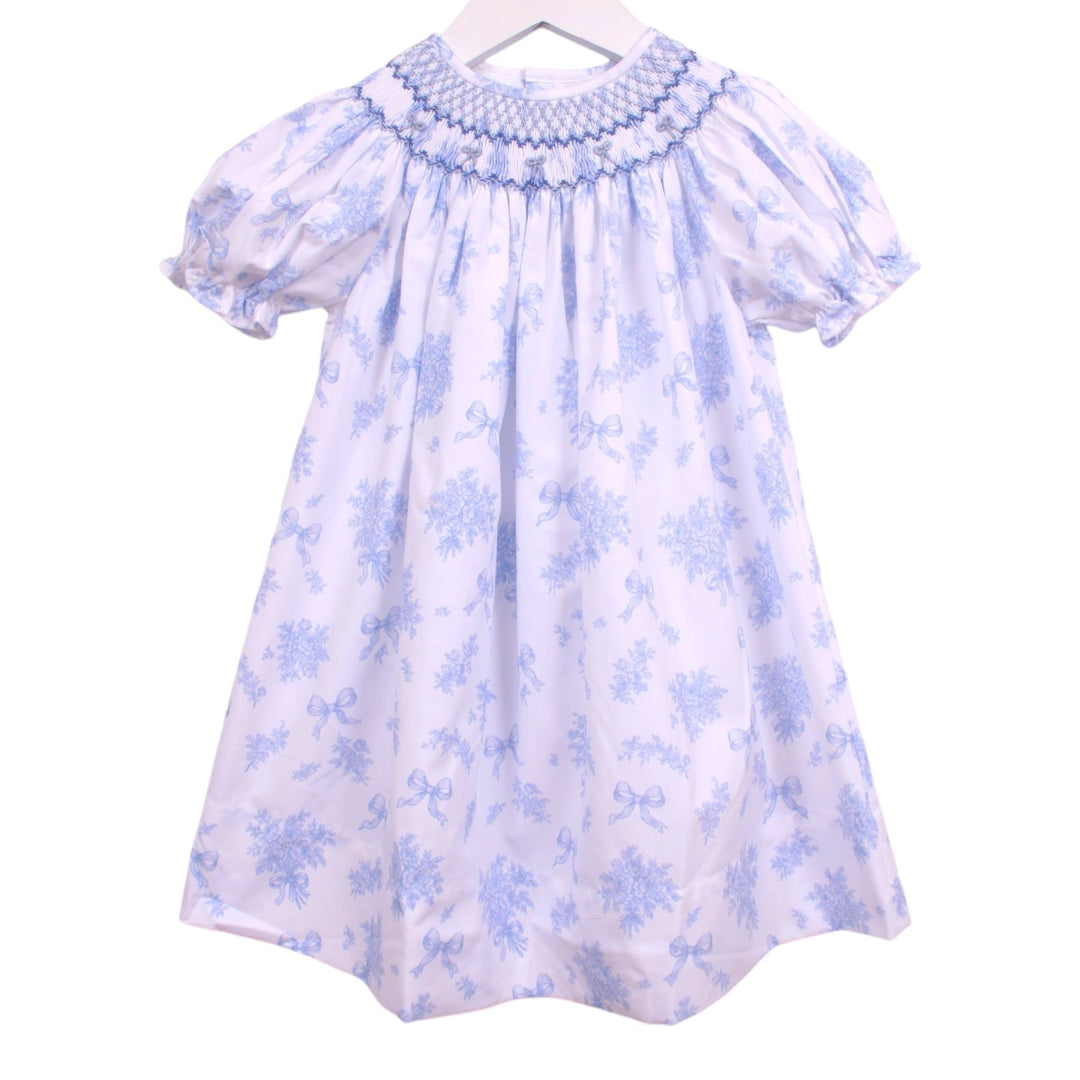 That Store Smocked Evelyn blue floral bishop dress with puff sleeves and geometric smocking on a white background