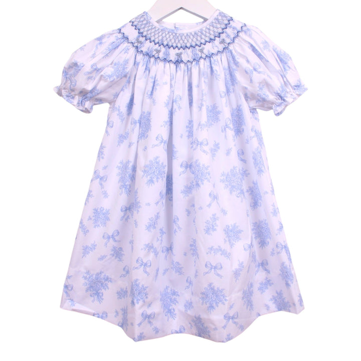 That Store Smocked Evelyn blue floral bishop dress with puff sleeves and geometric smocking on a white background