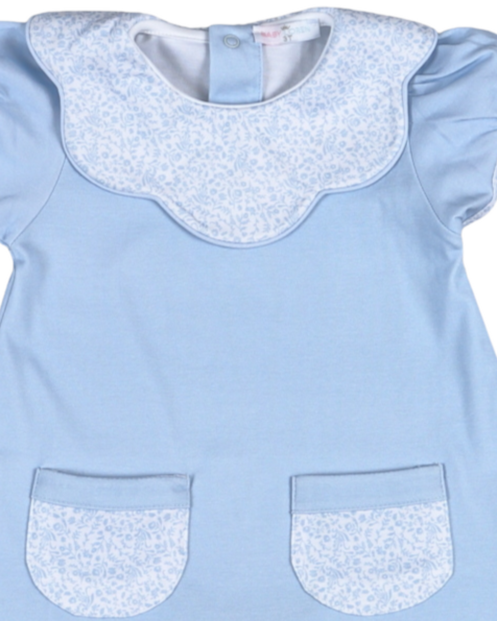 Light blue dress with white floral collar and pocket trim on a white background