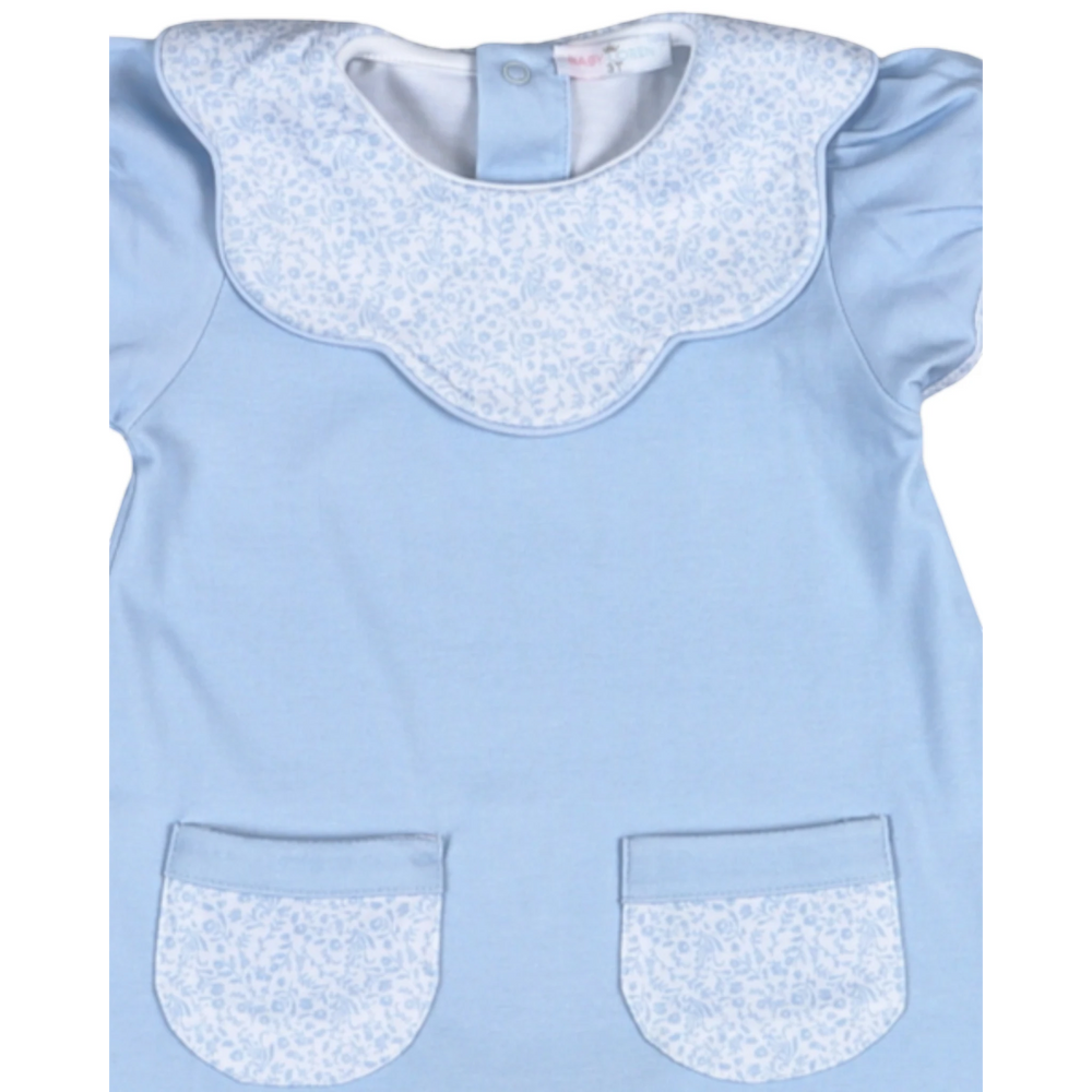 Light blue dress with white floral collar and pocket trim on a white background
