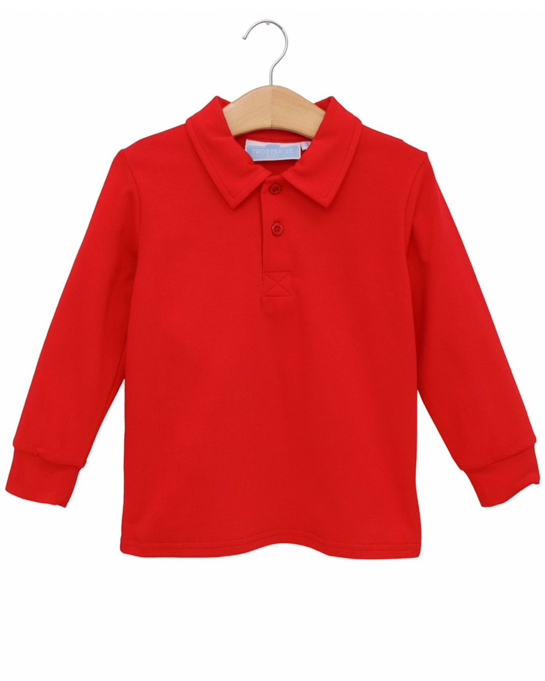 A bright red long-sleeve polo shirt for kids, hanging on a wooden hanger against a plain white background, that store