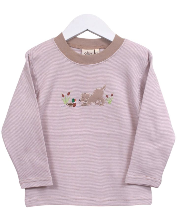 A light pink long-sleeve baby t-shirt with a beige crew neck and a central embroidered dog motif, hanging on a white hanger against a white background, that store