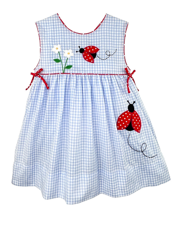 Children's dress with ladybug design on a white background